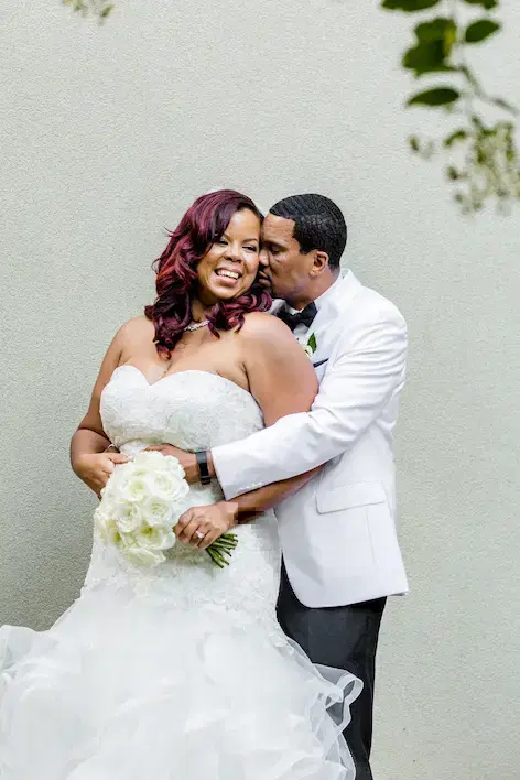 Black bride and groom smiling.