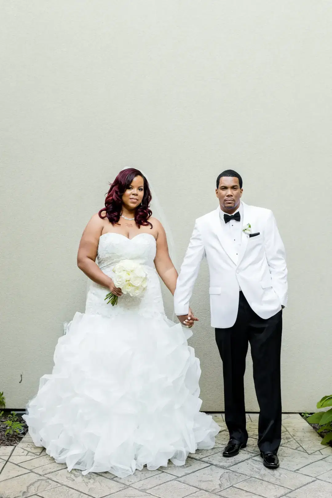 Newly wed couple posing for wedding photos.