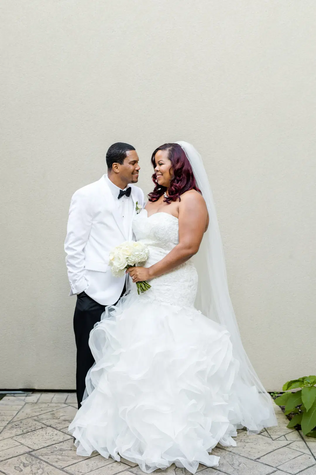Newly wed couple posing for wedding photos.