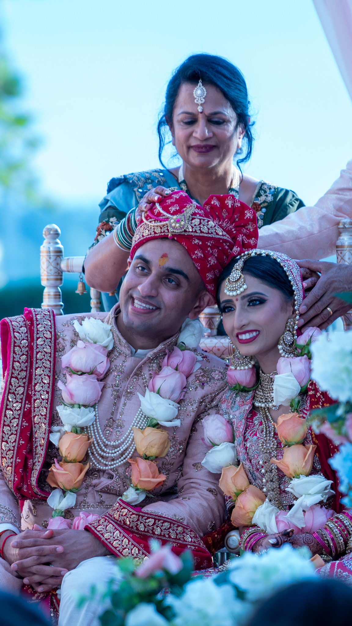 Indian newlywed couple smiling.